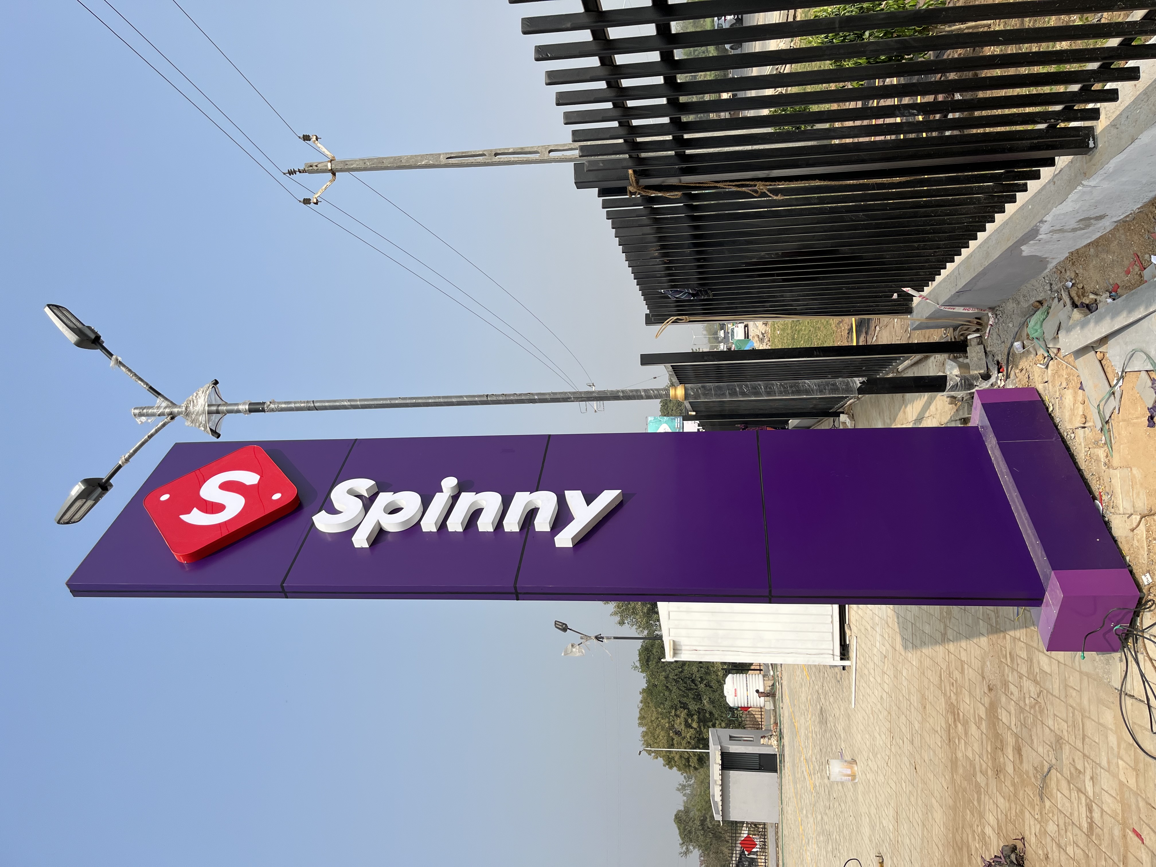Retail brand signage installation — Spinny
